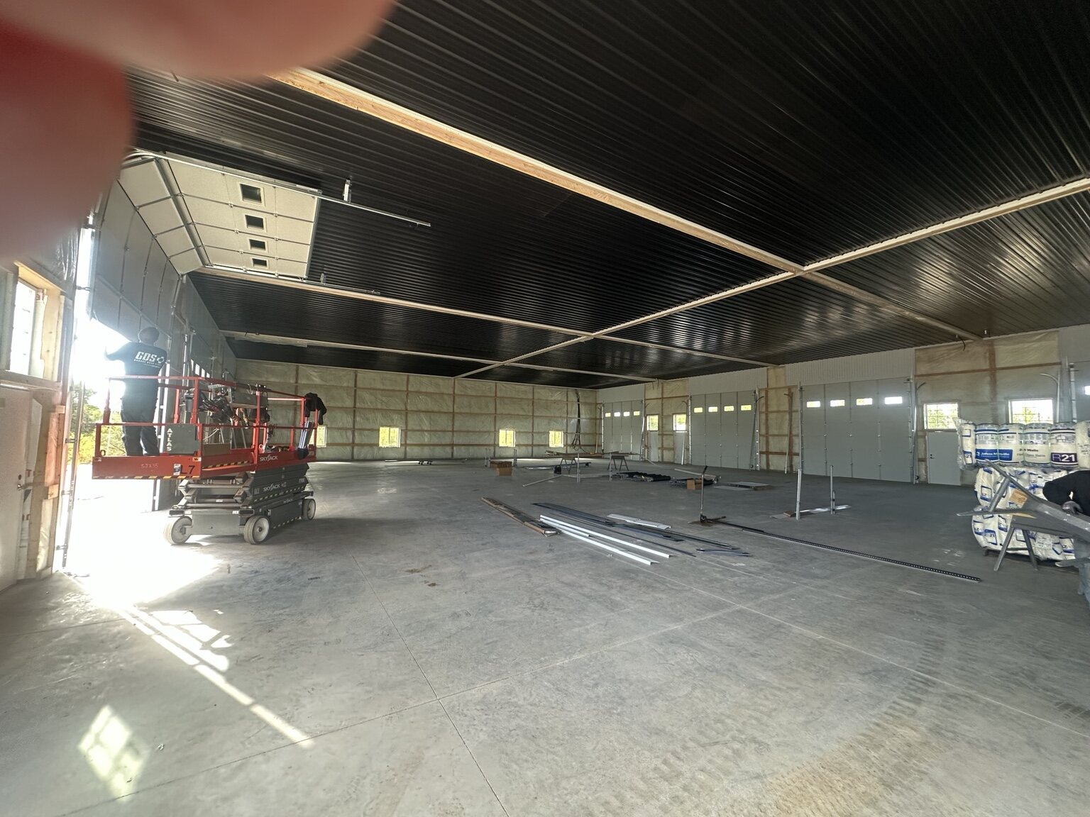 Large Building 3 interior area during construction with garage doors and ceiling panels installed